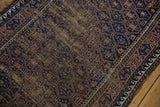 Navy and brown geometric trellis, showing mostly even pile wear.