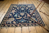 Antique Chinese rug detail: navy blue field with Persian stylized palmettes, lotus, and vinery motifs.