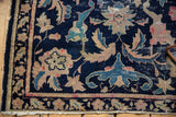 Antique Chinese rug corner: navy field, beige, pink, aqua Persian palmettes, visible foundation, tattered.