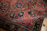 Vintage Sarouk rug pile with mostly even wear, deep blush and navy floral vinery.