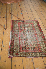 Red, ivory, and brown meandering vine border and floral trellis on antique Hamadan rug with wear.