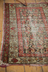 Detailed view of antique Hamadan rug's red, charcoal, and ivory floral trellis, showing even wear.
