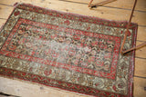 Hamadan rug corner, red, ivory, brown floral border, showing wear and tattered ends.