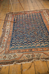 Antique Persian Hamadan rug detail with navy Mahi Mahi pattern, tangerine geometric border, and fringe loss.