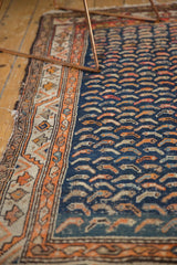 Navy Mahi Mahi motif alongside tangerine geometric vine border on antique Hamadan.