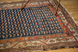 Navy blue, saffron, tangerine antique Hamadan rug with geometric vine border and tattered edge.