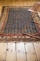 Antique Hamadan rug's lower edge, showcasing its aged fringe and storied wear.