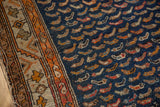 Mahi Mahi motifs and geometric border on a worn navy antique Persian Hamadan rug.
