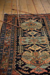 Vintage Hamadan rug with stylized floral cross sections and shrimp motifs in navy, rust, and sky blue.