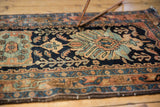 Vintage Hamadan rug end, showing light tatter, low pile, with navy and rust colors.