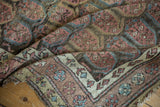 Antique Northwest Persian runner's folded corner, revealing rose, blue boteh design, and worn fringe.