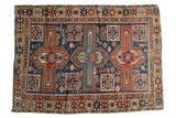 Antique hand-knotted Caucasian rug, geometric repeating boteh pattern in navy, madder red, saffron.
