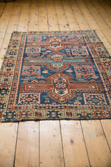 Detail of antique Caucasian rug, geometric boteh design, navy blue, madder red, and patina.