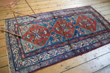 Vintage Persian Malayer runner: abrashed blue and red ground with geometric Herati motifs.