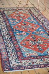 Abrashed watery blue ground and cherry red patterns on a vintage Malayer rug.