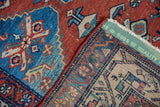 Detail of vintage Malayer rug showing low pile, hand-knotted back, and 'RUGS OF QUALITY' label.