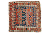 Antique Serapi square rug featuring navy blue field, double red medallions, and varied geometric borders.