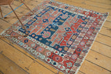 Persian Serapi's distinct asymmetric red, navy, and ivory border design details.