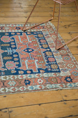 Antique Serapi rug: asymmetric border in madder red, navy; light tattered fringe.