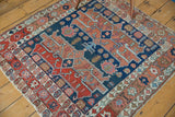 Varied geometric motifs in the corner border of an antique Serapi rug, with light tatter.