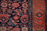 Antique Malayer rug with navy Herati motif and early inspired ruby red grapefruit border.