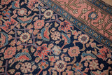 Antique Malayer runner's Herati motif on navy, framed by a blush-toned Herat-inspired border.