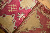 Hand-knotted Turkish Yastik rug showing its woven reverse, tattered end, and border details.