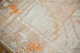 Distressed Oushak rug's textured pile, with even wear, tangerine floral and geometric motifs.