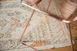 Distressed vintage Oushak rug texture and geometric vinery motifs with tangerine accents.