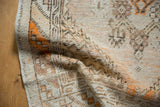 Aged pile and distressed texture of a vintage Oushak rug, with tangerine accents.