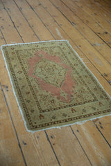 Distressed antique Jalili Tabriz rug with low pile and dusty pink medallion.