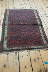 Antique Belouch rug detail: serrated diamond patterns, reciprocating wave, and plant border motifs.
