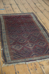 Belouch rug corner detail with tattered fringe, triple stripe, and reciprocating wave borders.