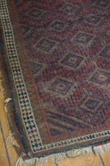 Antique Belouch rug's distinctive triple stripe border and diminutive plant motifs, aged fringe.