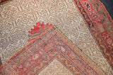 Folded corner of the antique Malayer rug, displaying its tightly woven foundation and edges.