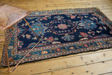 Detailed blush, sky blue floral motifs on low pile of vintage Baktiari rug.