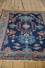 Low pile, hand-knotted fringe, and indigo blue floral border on a vintage Baktiari rug.