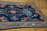Secured side and intricate border of vintage Baktiari rug with blush and sky blue florals.