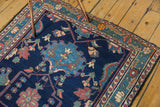 Detailed pattern of the Persian Baktiari rug's border with indigo and blush floral motifs.