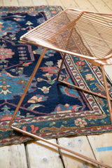 Visible low pile of hand knotted Baktiari rug with indigo, blush, and sky blue floral motifs.