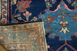 Vintage Baktiari rug corner, showing indigo low pile and intricate woven foundation.