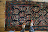 Antique Northwest Persian rug with allover boteh pattern, multi-color borders, wear, and feet.