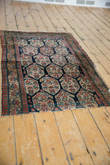 Antique Northwest Persian rug's navy hexagonal boteh pattern with red and ivory pawn borders.