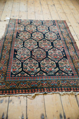 Tattered fringe and lower border of an antique Northwest Persian rug, showing pawn motifs.