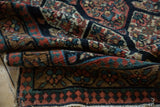 Tattered fringe and detail of reciprocating pawn border on an antique Persian rug.