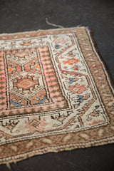 Close-up of dusty rose, ivory paneled medallions, and reciprocating pawn geometric border.
