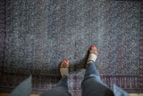 Muted ivory, navy, and cochineal red boteh paisley pattern on an antique Doroksh rug.