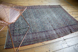 Persian Doroksh antique rug corner: ivory, cochineal red, navy blue allover paisley design, scrolling border.