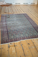 Antique Doroksh rug: cochineal red scrolling paisley border, ivory field, and visible wear.