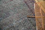 Persian Doroksh rug detail: allover ivory, navy, cochineal boteh paisley, mostly even wear.